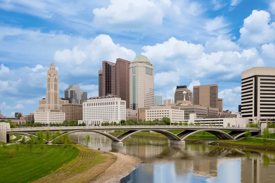 Skyline of Columbus, Ohio with bridge and river.